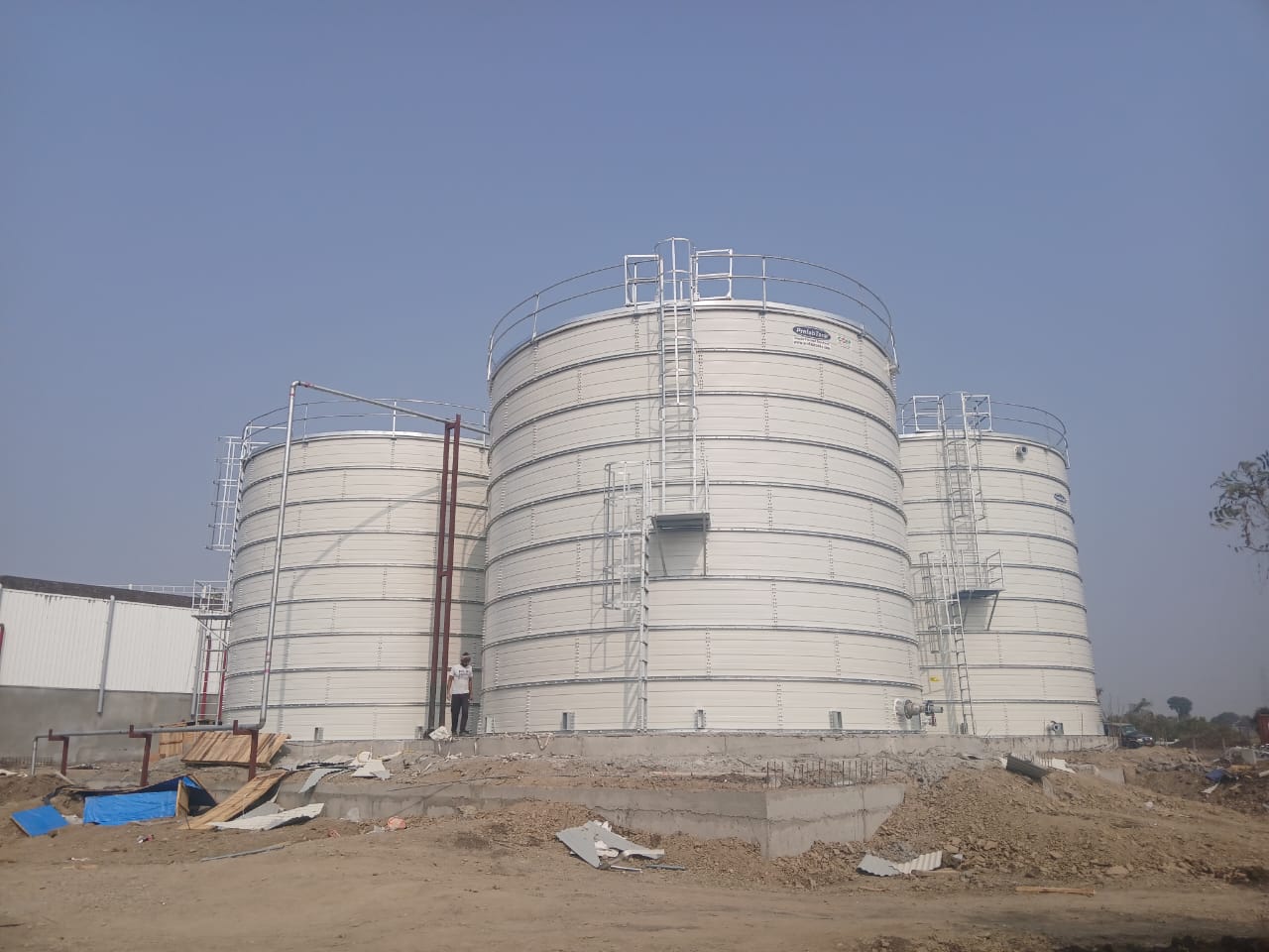 Large white Zinc Aluminium Steel tanks installed at an industrial site