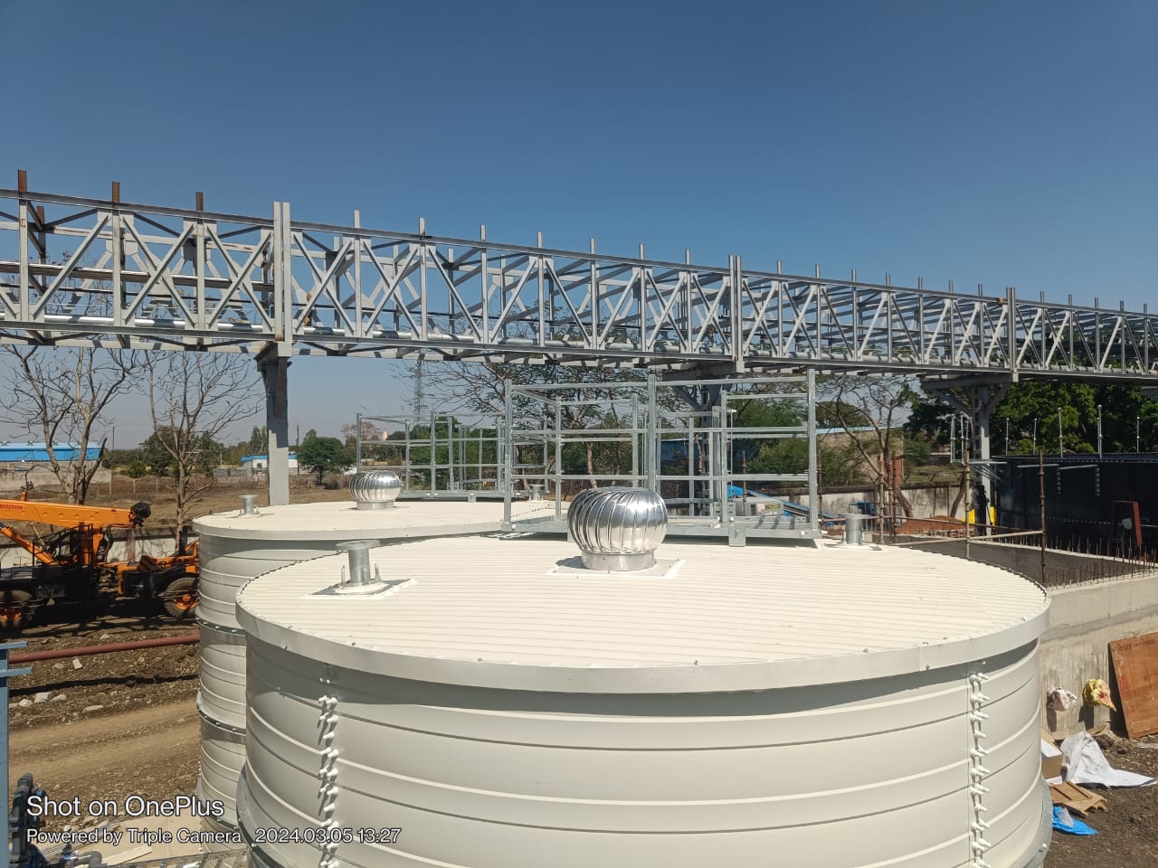 White Zinc Aluminium Steel tank roof below a steel walkway structure