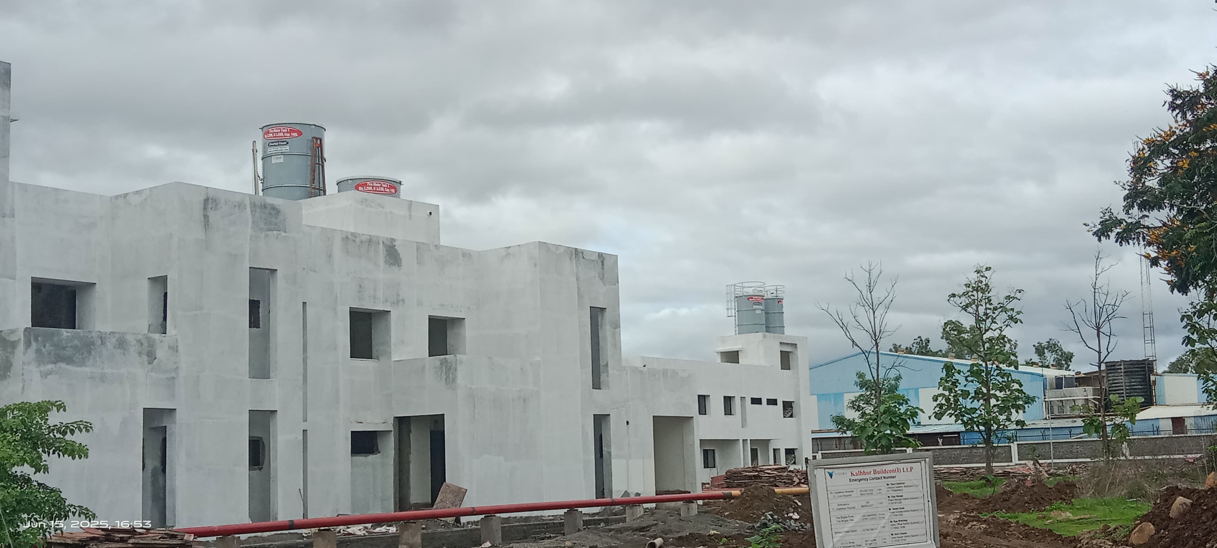 Zinc Aluminium Steel rooftop tanks on a building project under cloudy skies