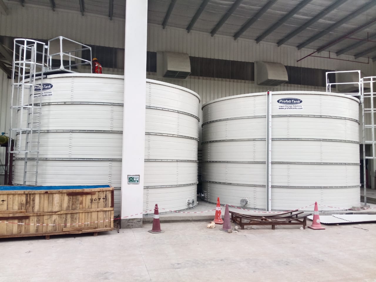 Twin white Zinc Aluminium Steel tanks installed indoors at an industrial facility