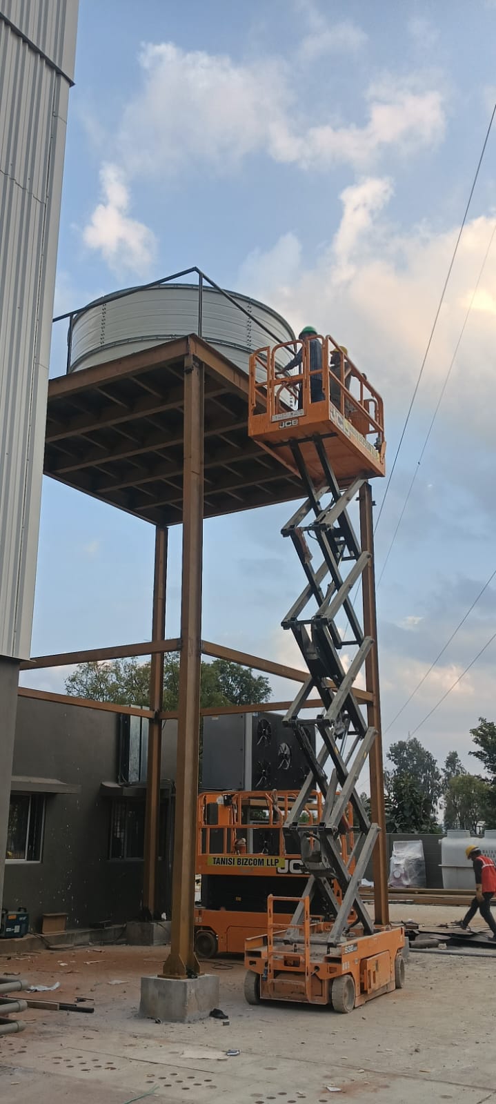 Elevated Zinc Aluminium Steel tank installed on a steel platform with lift access