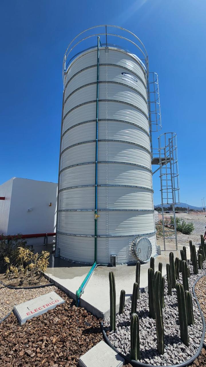 Tall white Zinc Aluminium Steel tank under clear sky