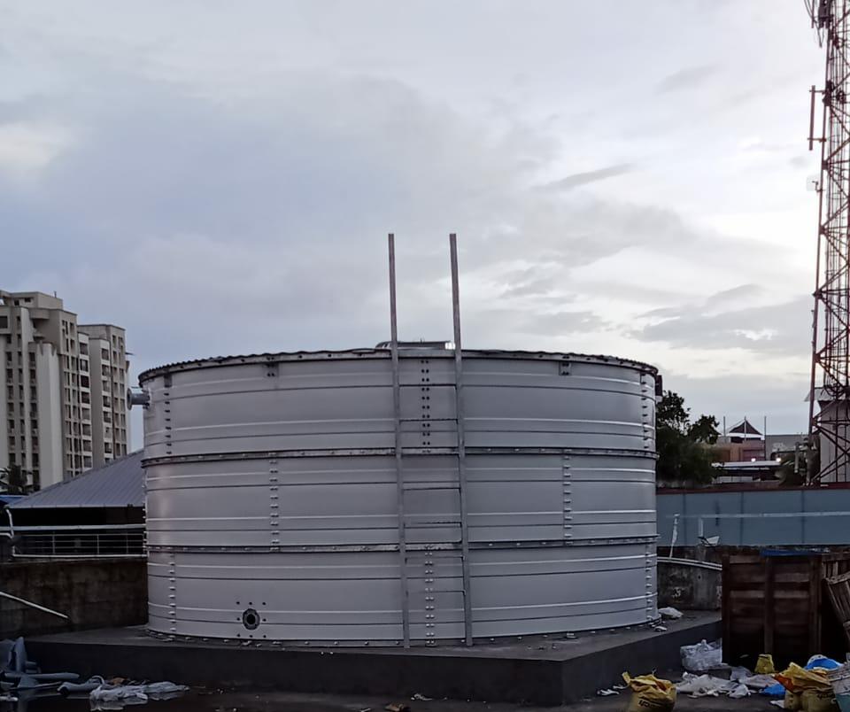 White Zinc Aluminium Steel tank installed on a concrete base under cloudy skies