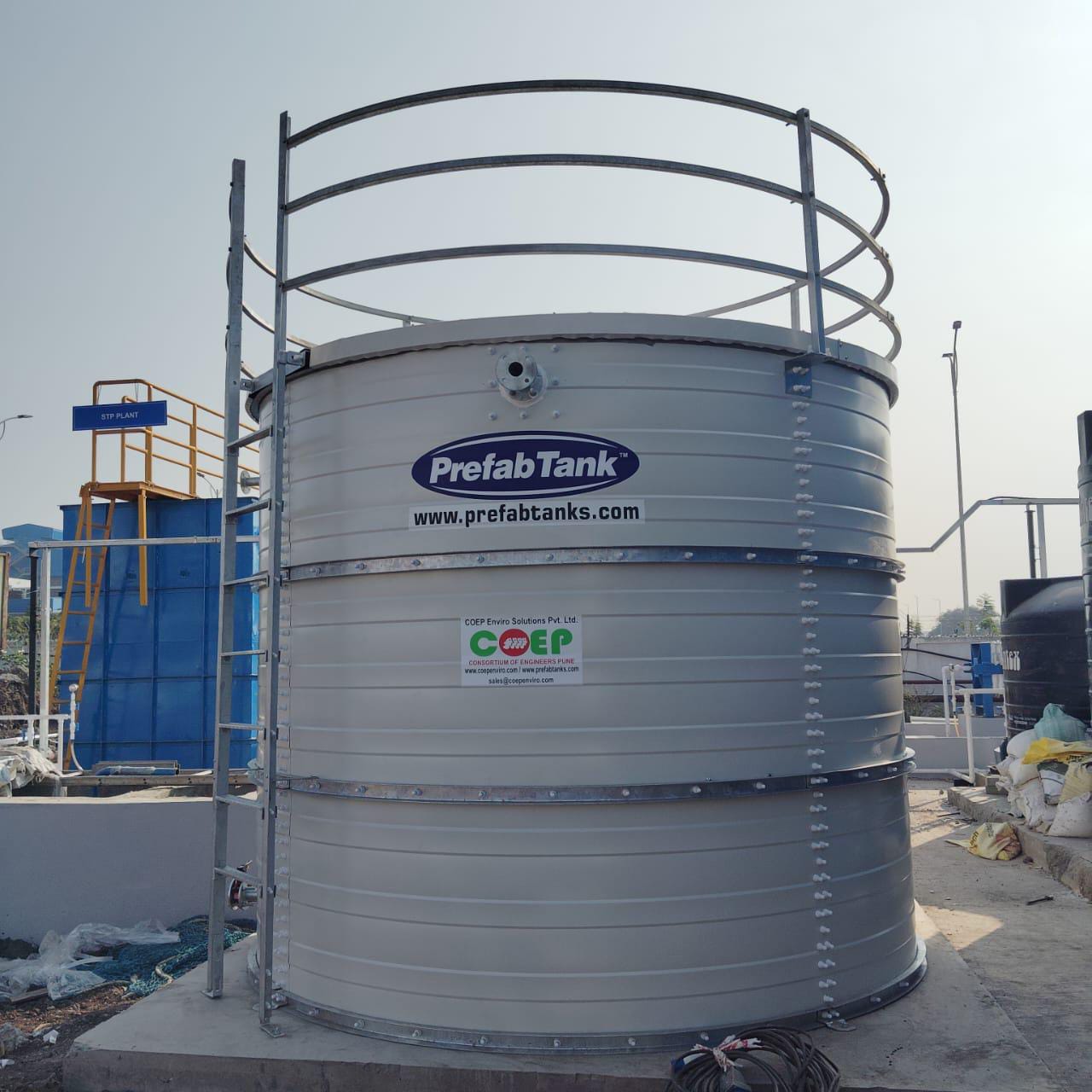 Covered Zinc Aluminium Steel tanks viewed from above with site team