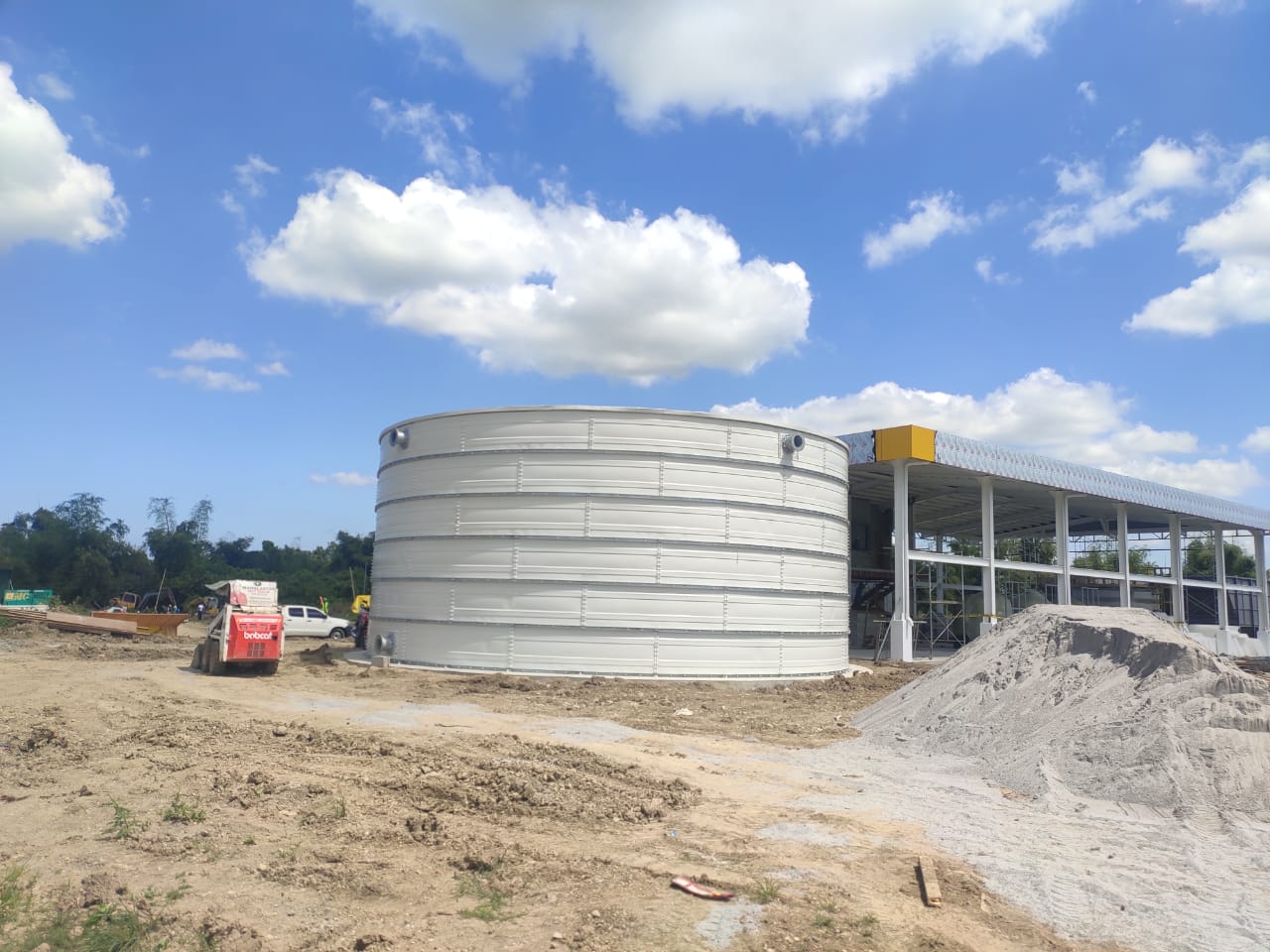 Zinc Aluminium Steel tank with roof installed among palm trees