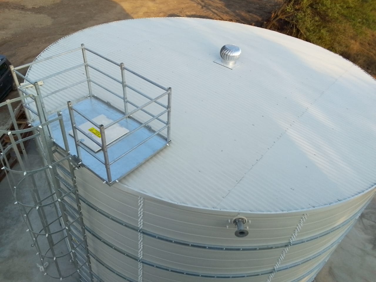 Zinc Aluminium Steel tank pair beside an industrial building