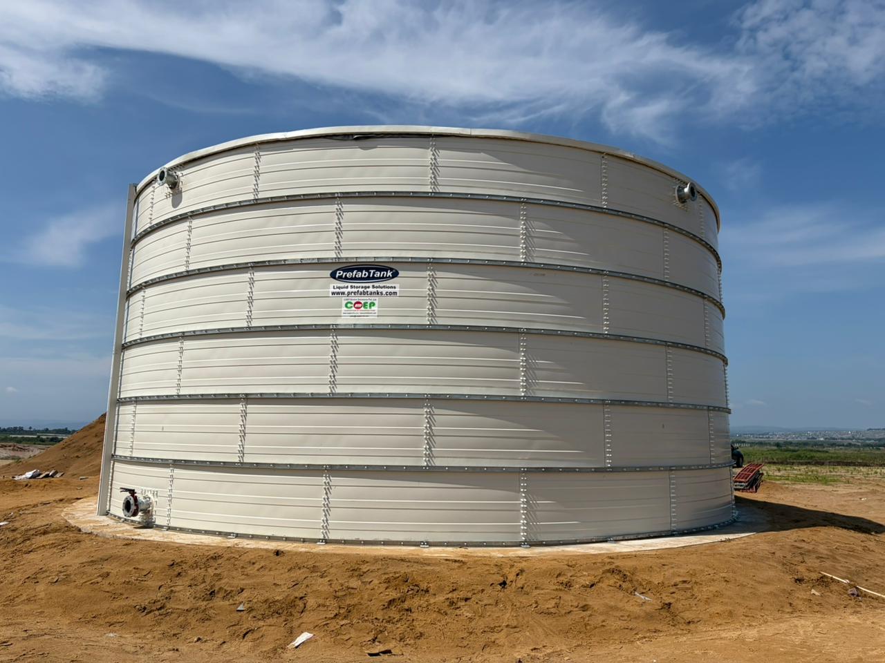 White Zinc Aluminium Steel tank at a green hillside project location